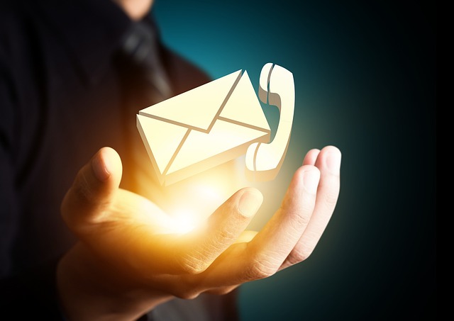 Hand mit Telefon- und Emailzeichen